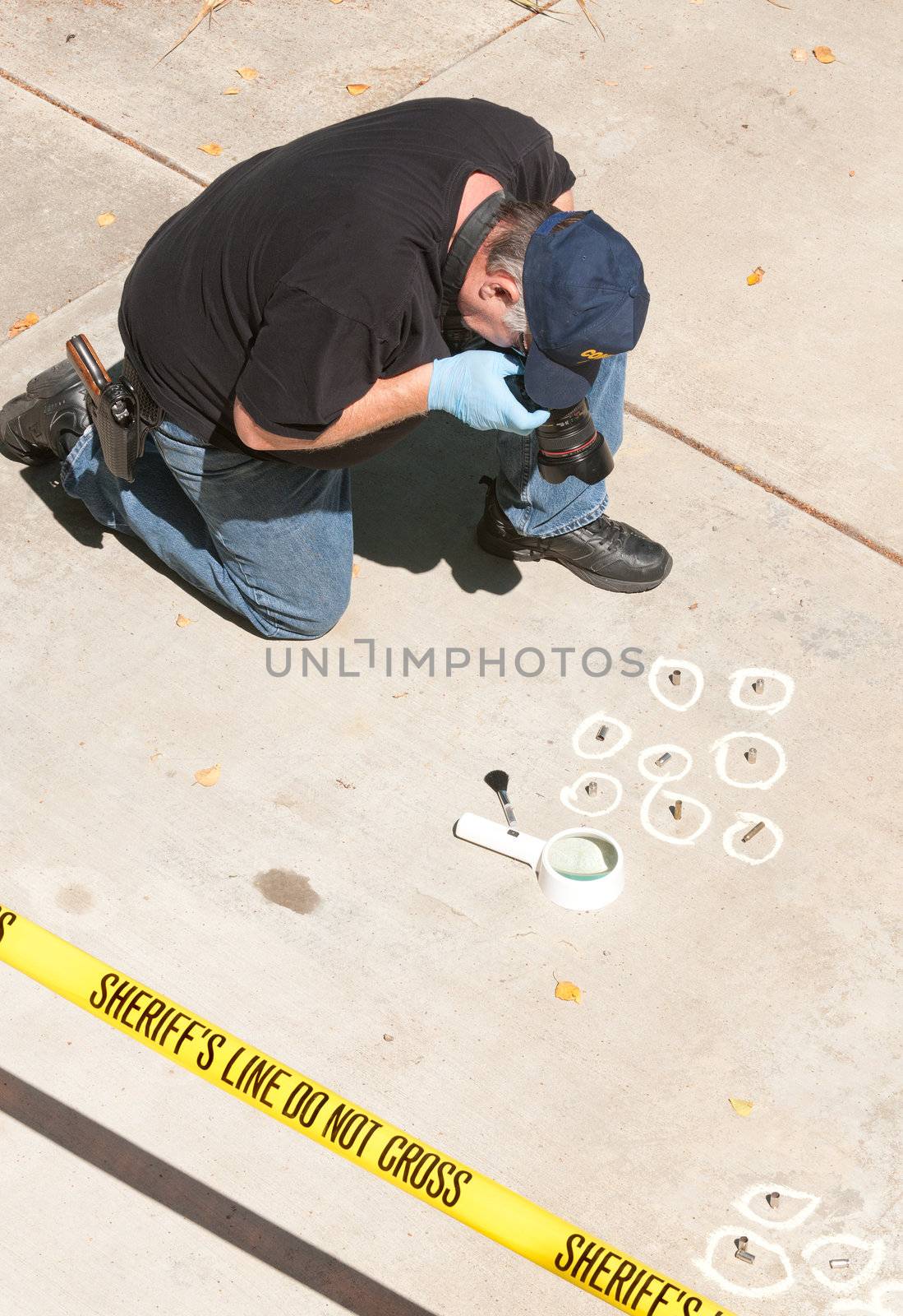 Detective studying a crimes scene taking photographs 