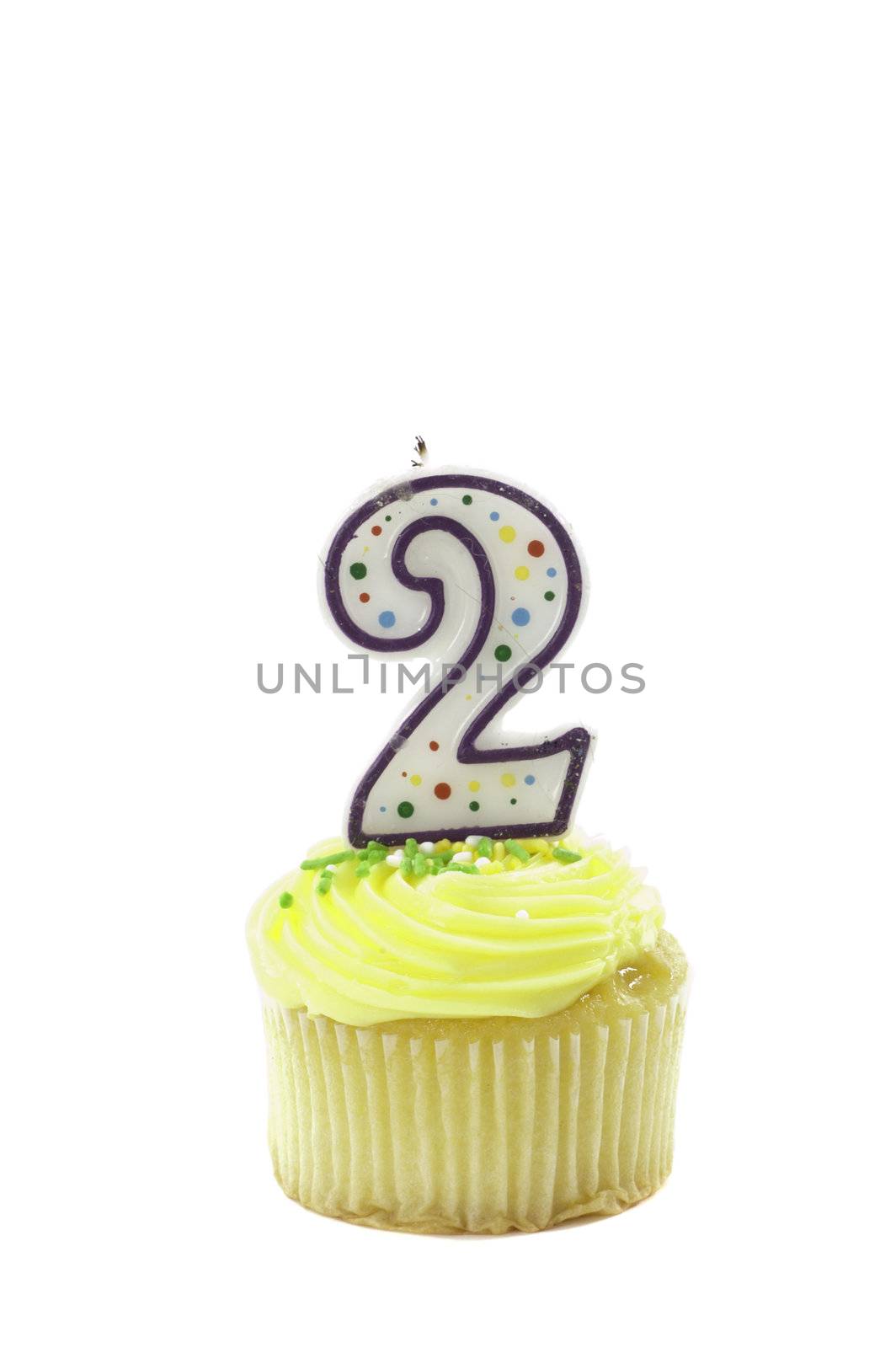 cupcake, isolated on white with a decorative candle in the shape of a number two