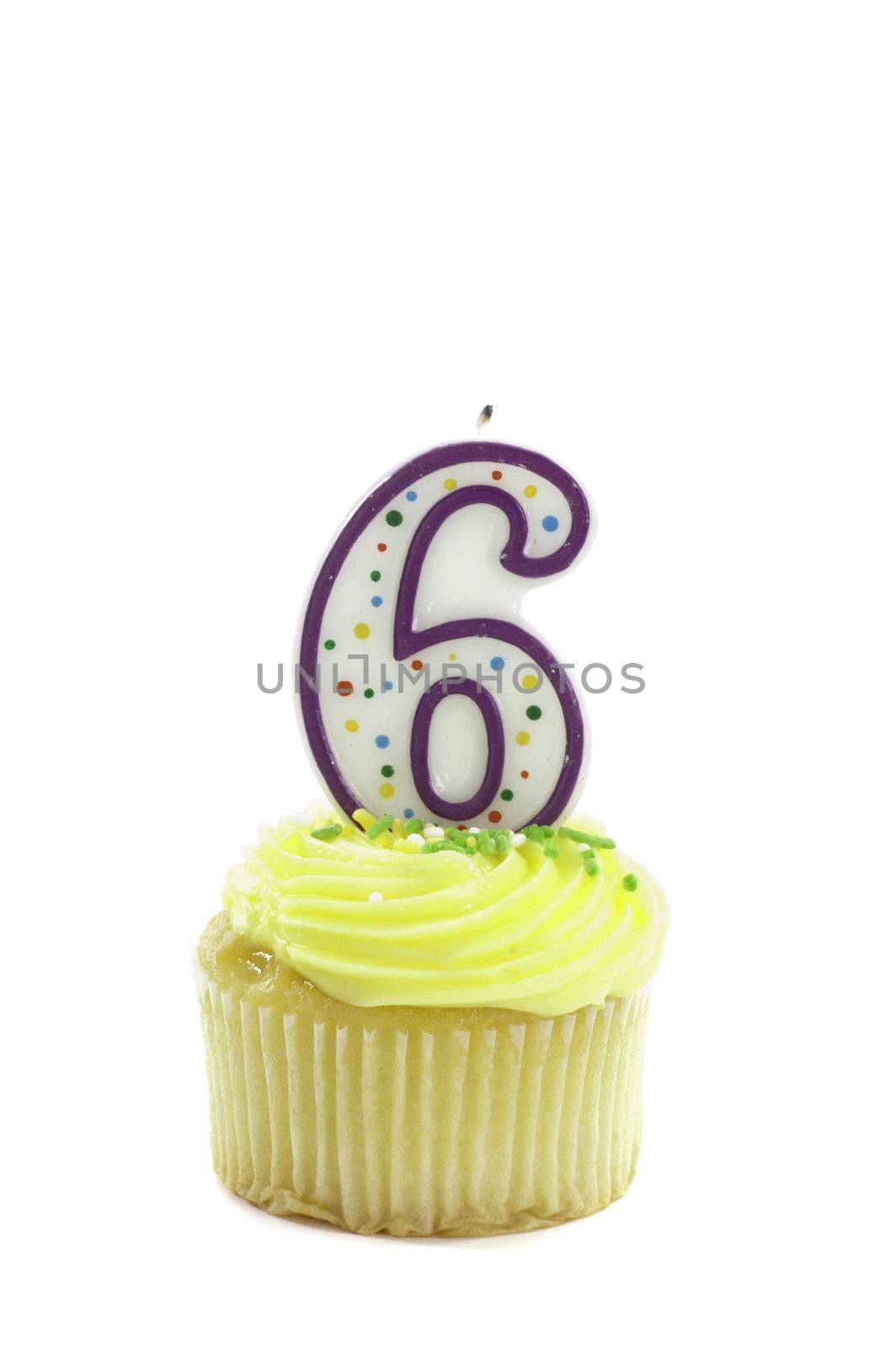 cupcake, isolated on white with a decorative candle in the shape of a number six