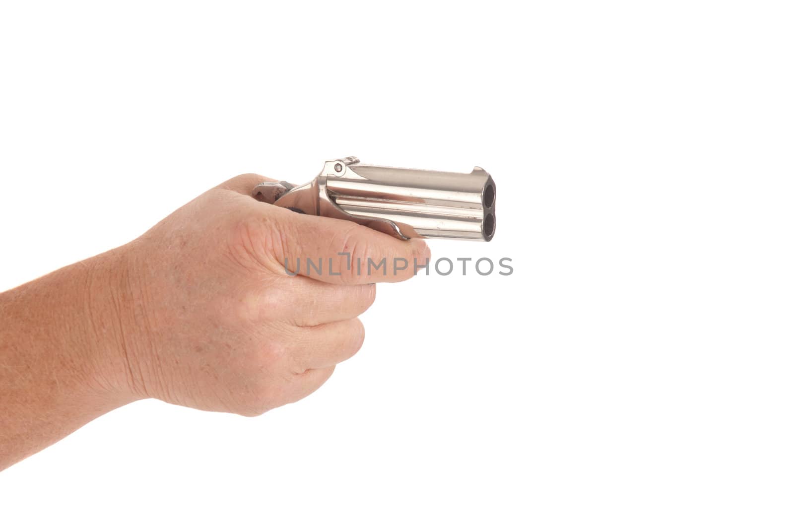 hand holding a double-barreled derringer pistol cocked ready to fire, isolated on white