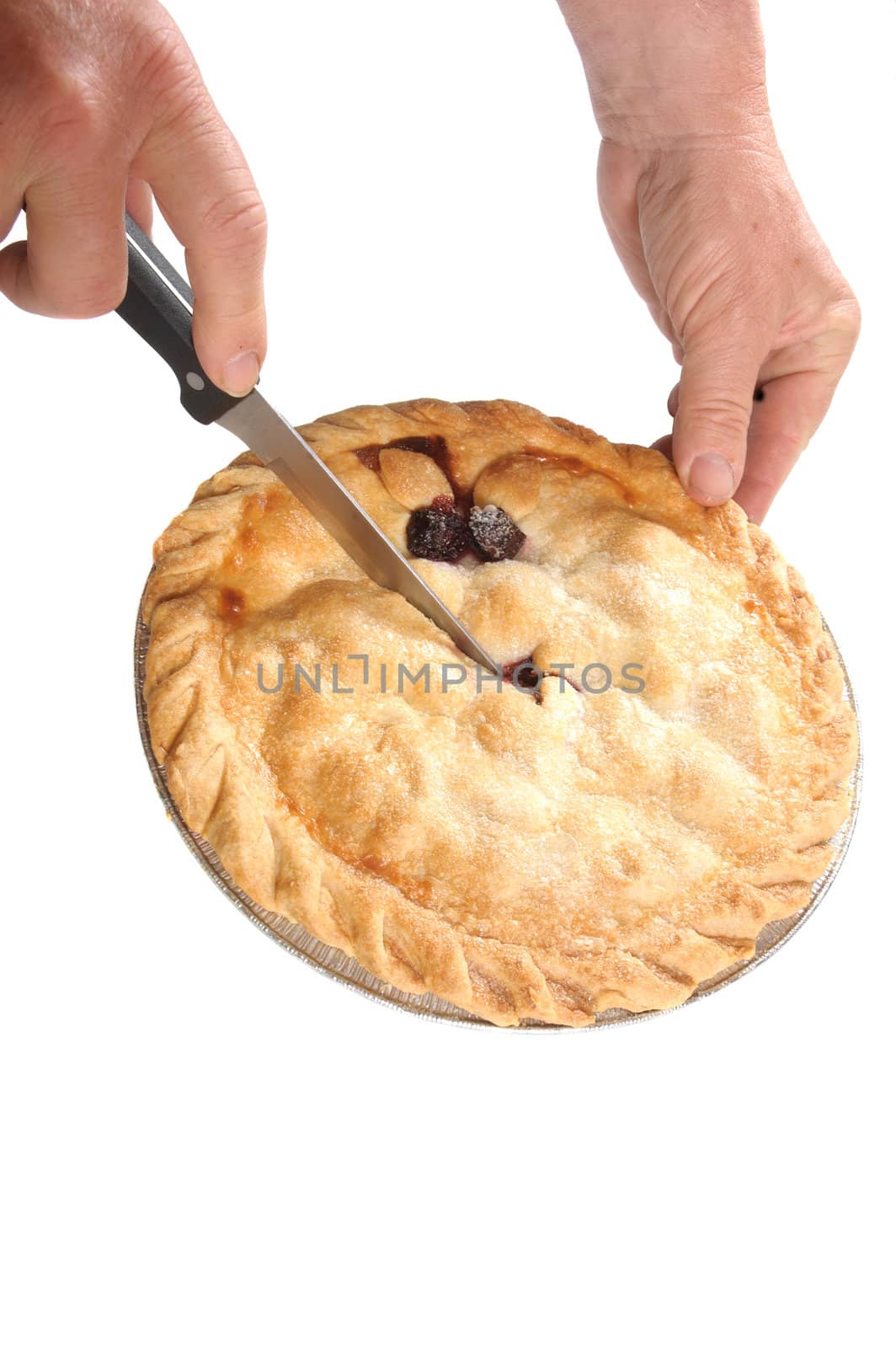 hand with knife cutting a Cherry pie, isolated on white
