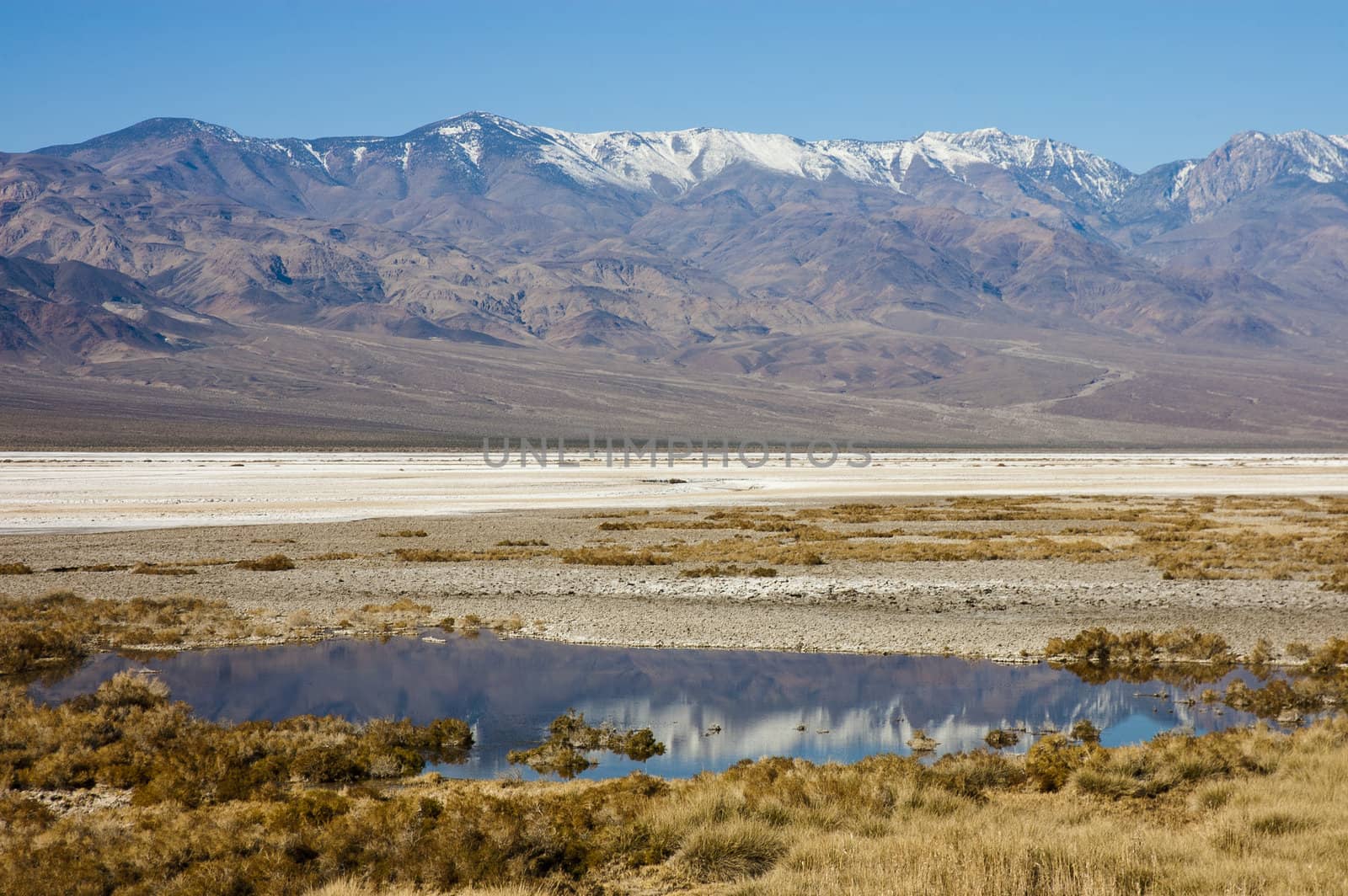 Seasonal lake formed in Death Valley during January with snow on the mountains