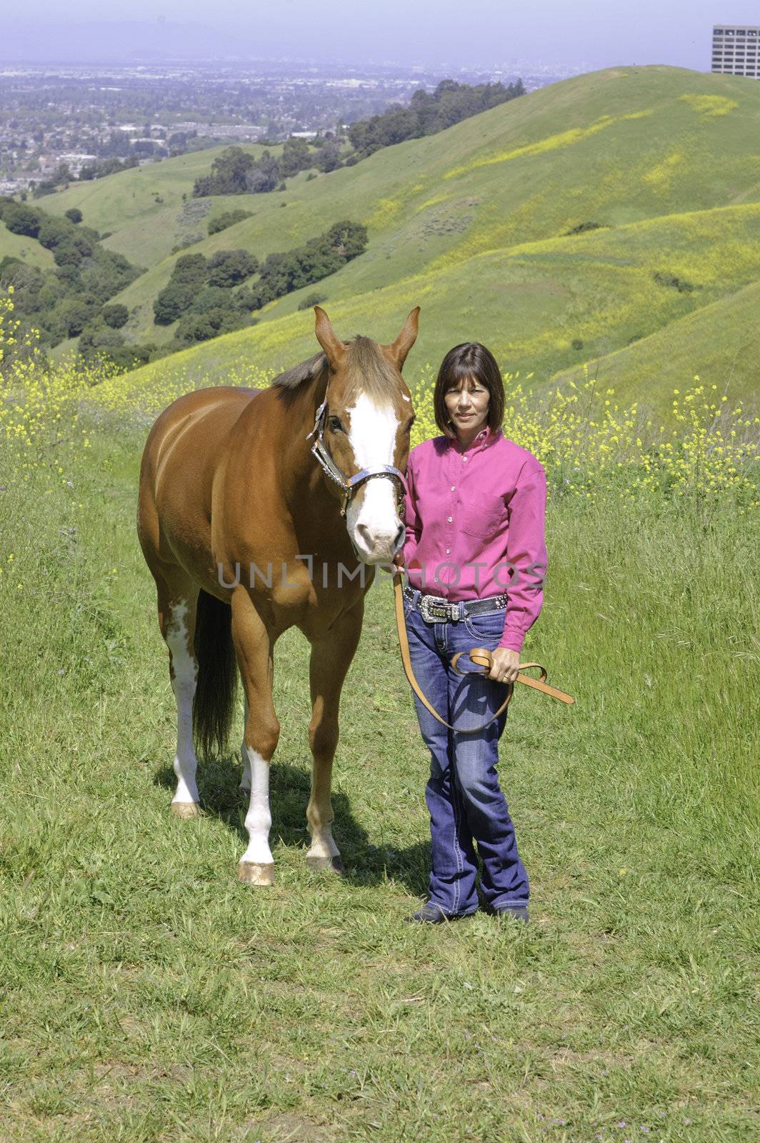 Closeup of attractive woman with her horse