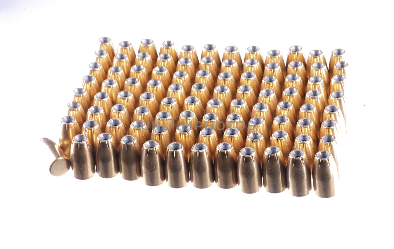 9mm bullets lined up in rows, isolated on white