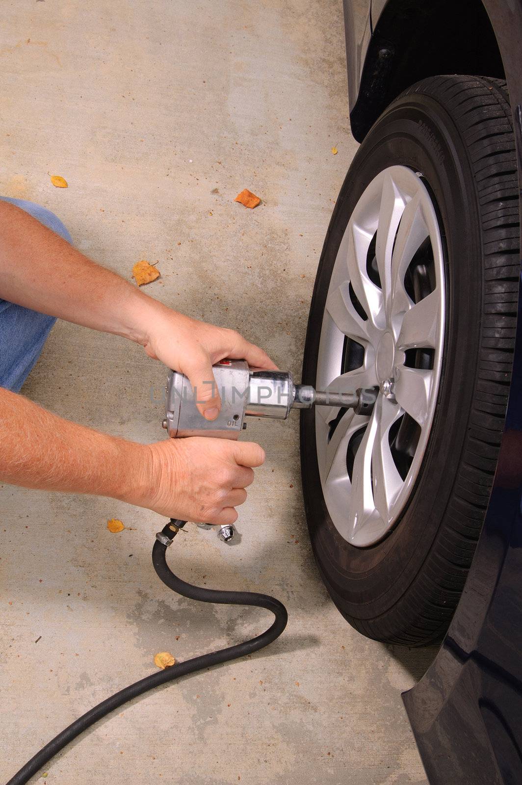 Mechanic changing tires by jeffbanke