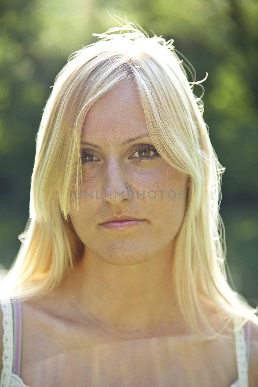 Beautiful blond woman resting in green environment