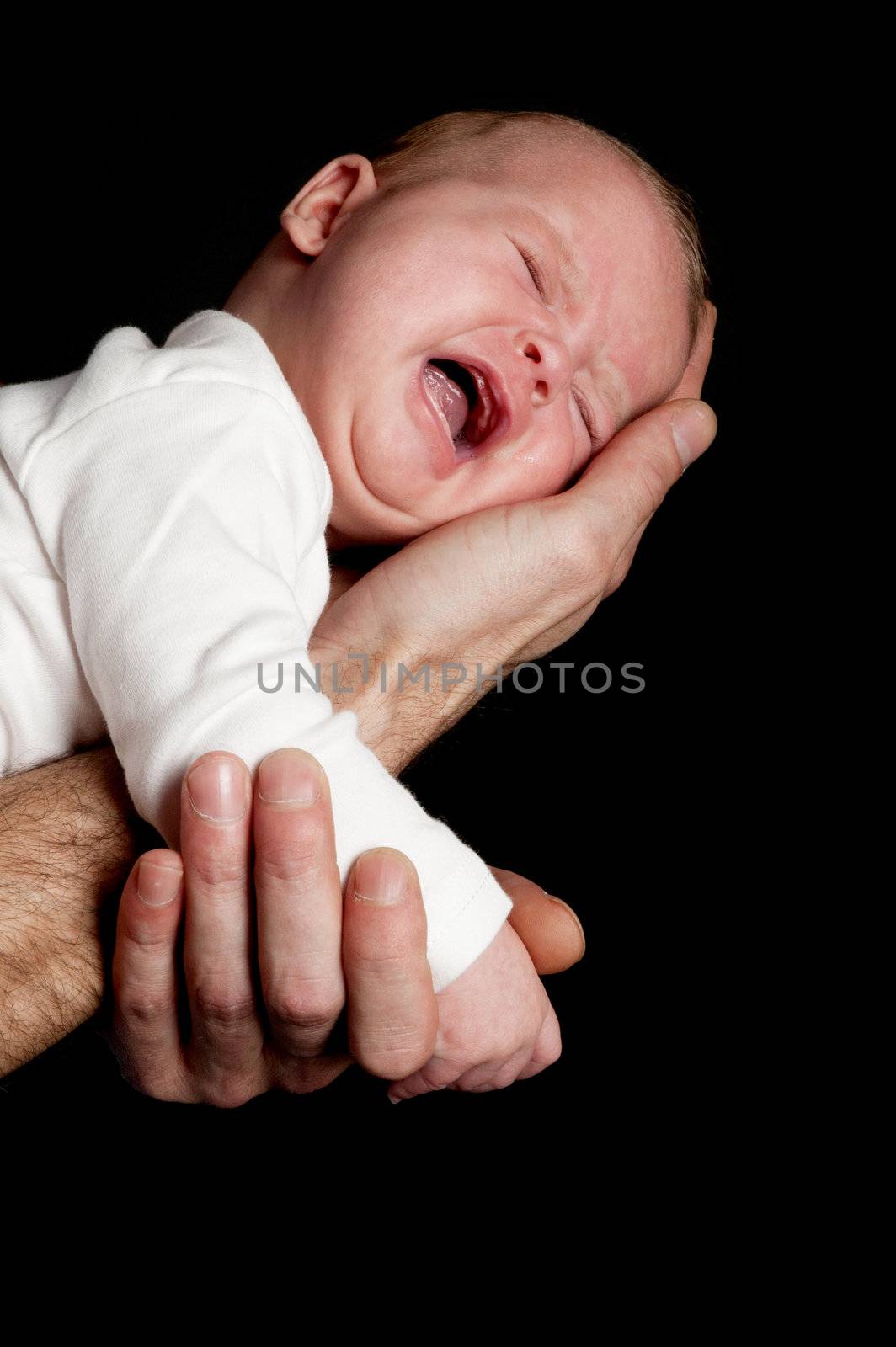 a fathers hand is holding a crying newborn baby by ladyminnie