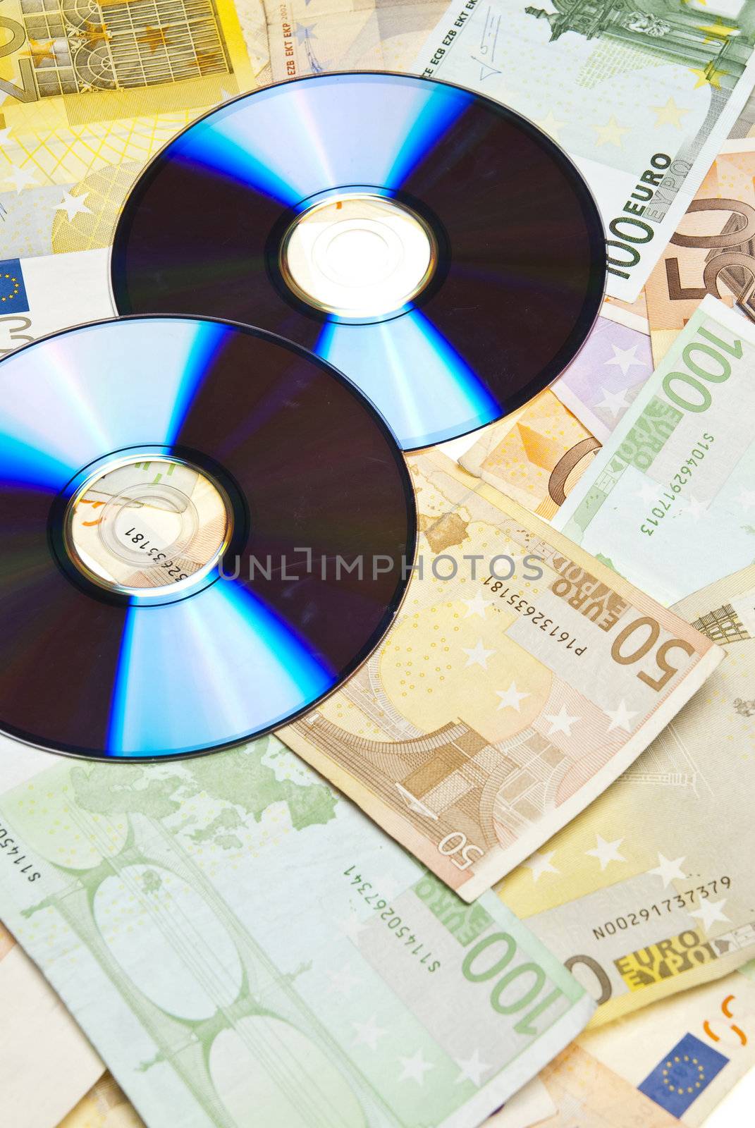 Compact Disks with euros below them,on white background.