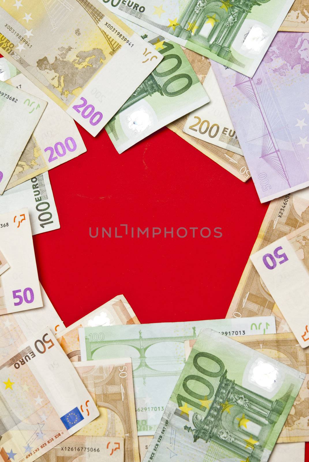 Euro bills on red background,recorded above them.