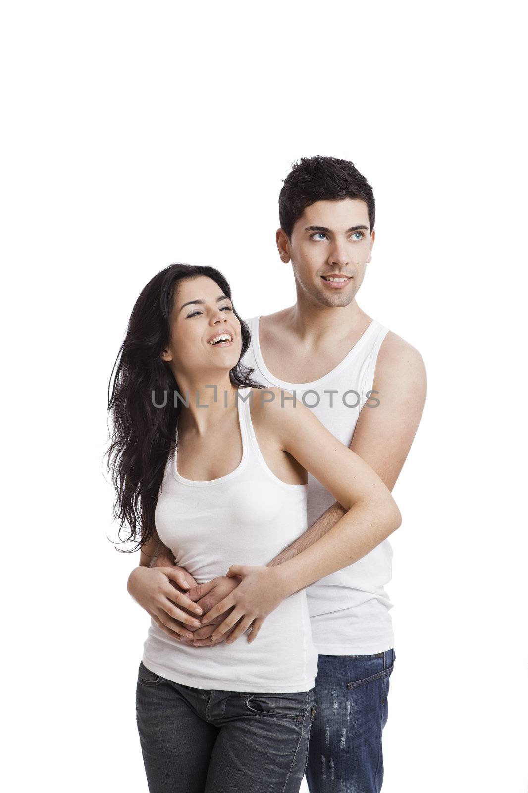 Beautiful and happy young couple standing over a white background