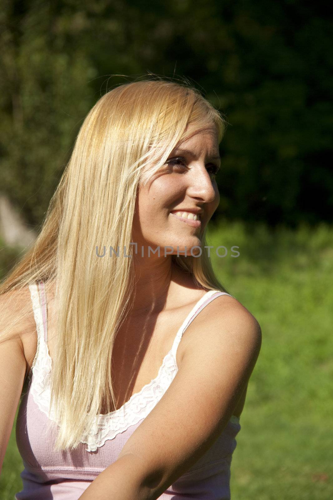 Beautiful blond woman resting in green environment