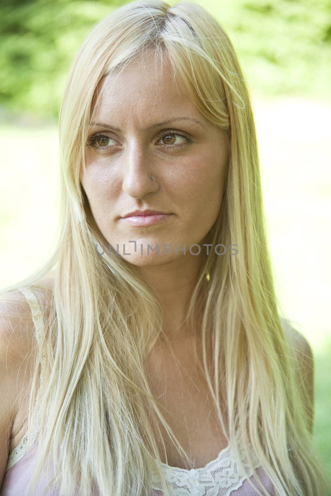 Beautiful blond woman resting in green environment