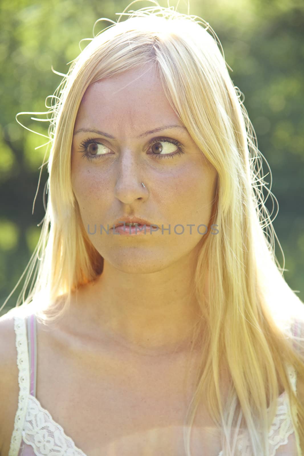 Beautiful blond woman resting in green environment