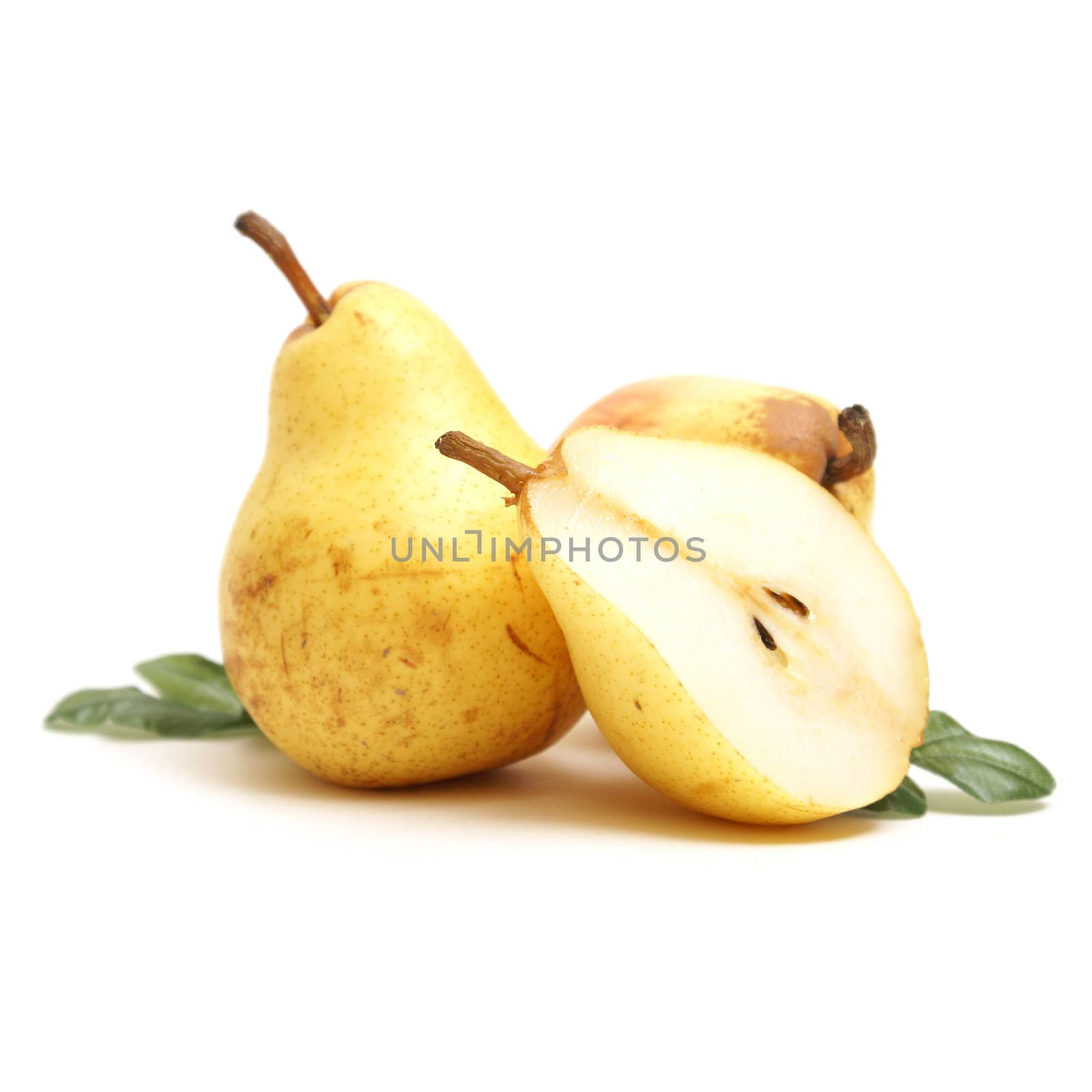 A few isolated pears with one that is cut in half.