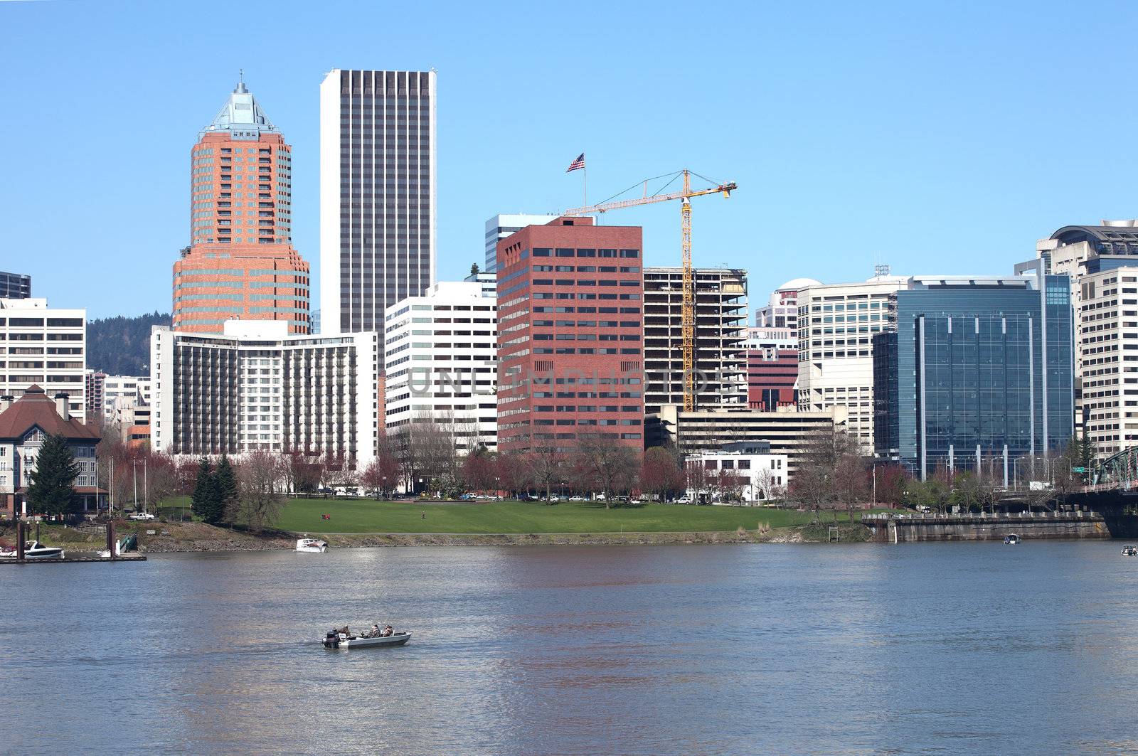 Fishing boats roam the downtown river in Portland Oregon on the first day of spring.