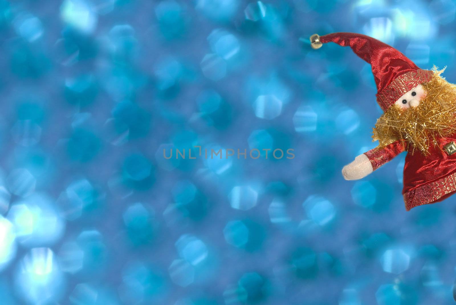 Funny Christmas elf on a blue background out of focus