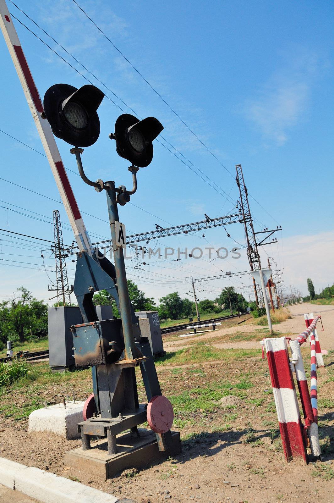 Traffic lights at a railway crossing and railroad.