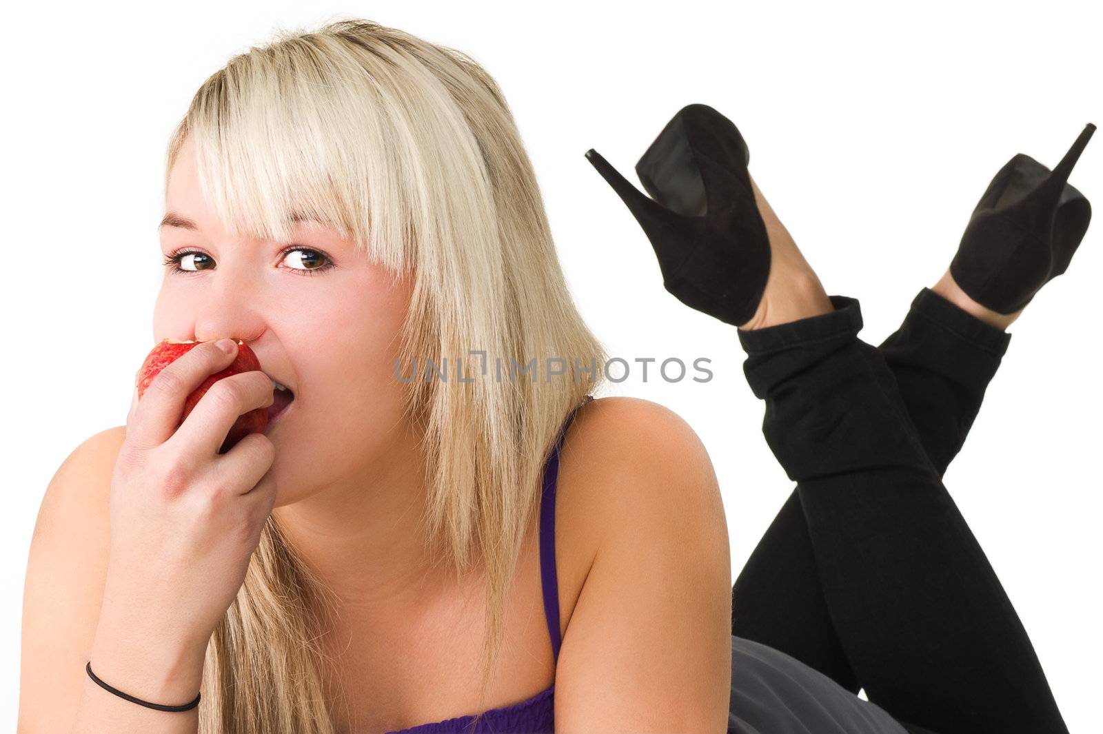 Young girl eating an apple over white background