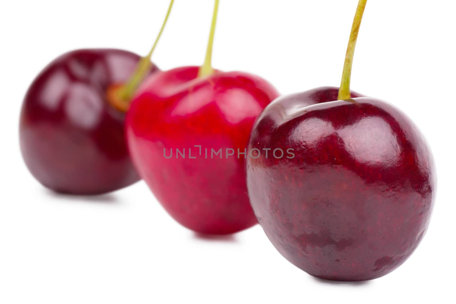 Close up view of heart shaped cherries over white background