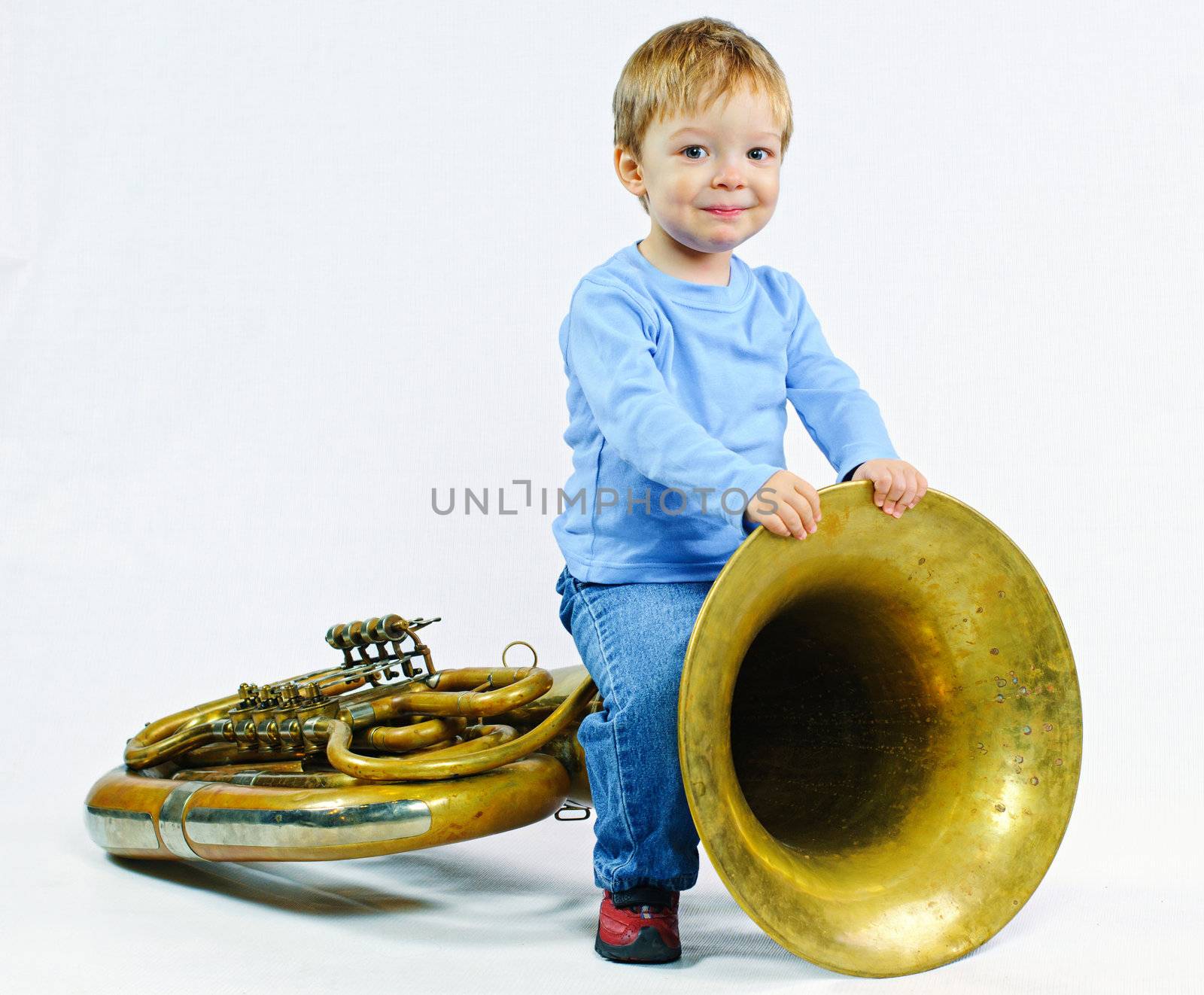 Little musician. Little cute boy and tuba