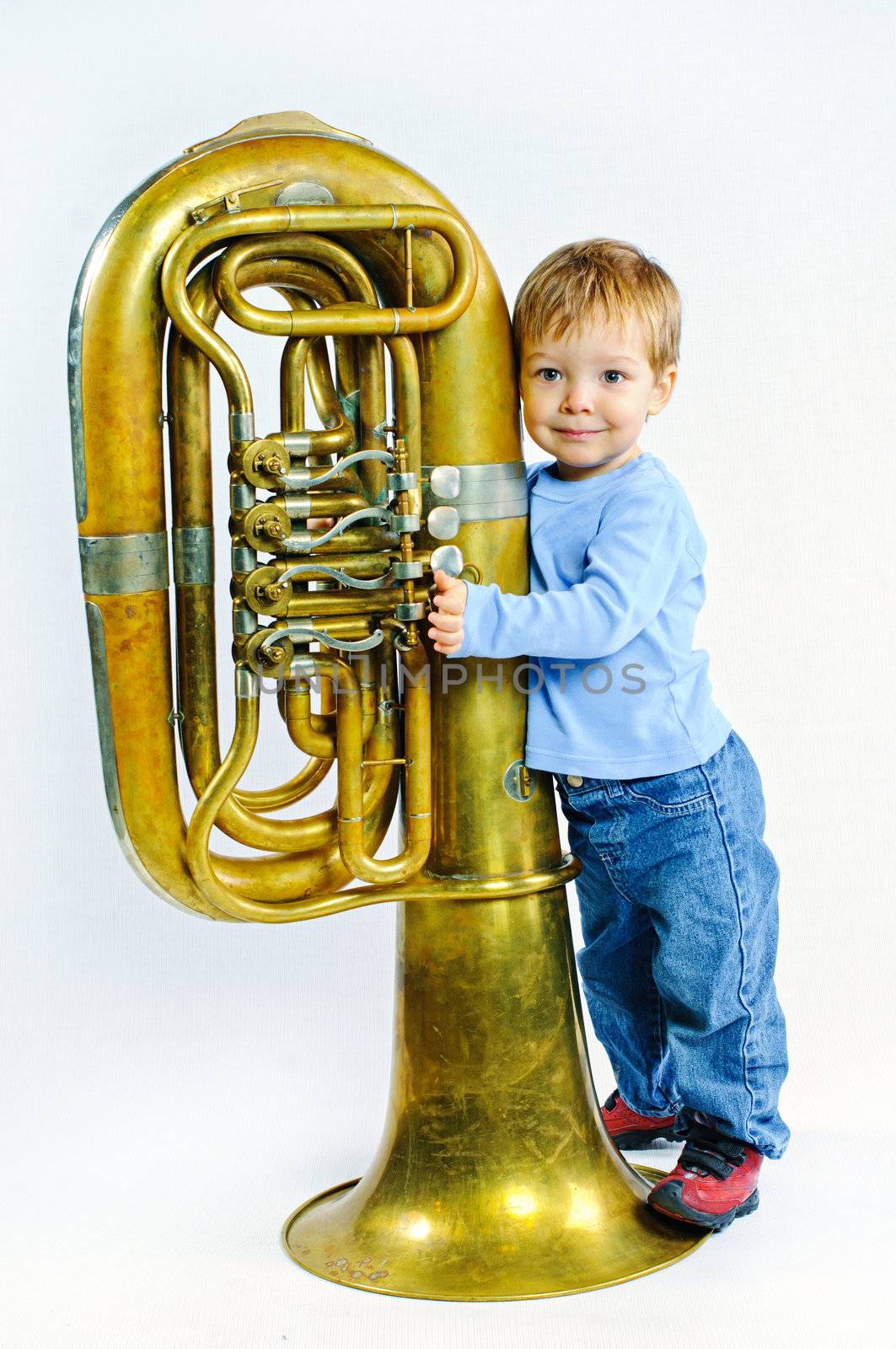 Little musician. Little cute boy and tuba