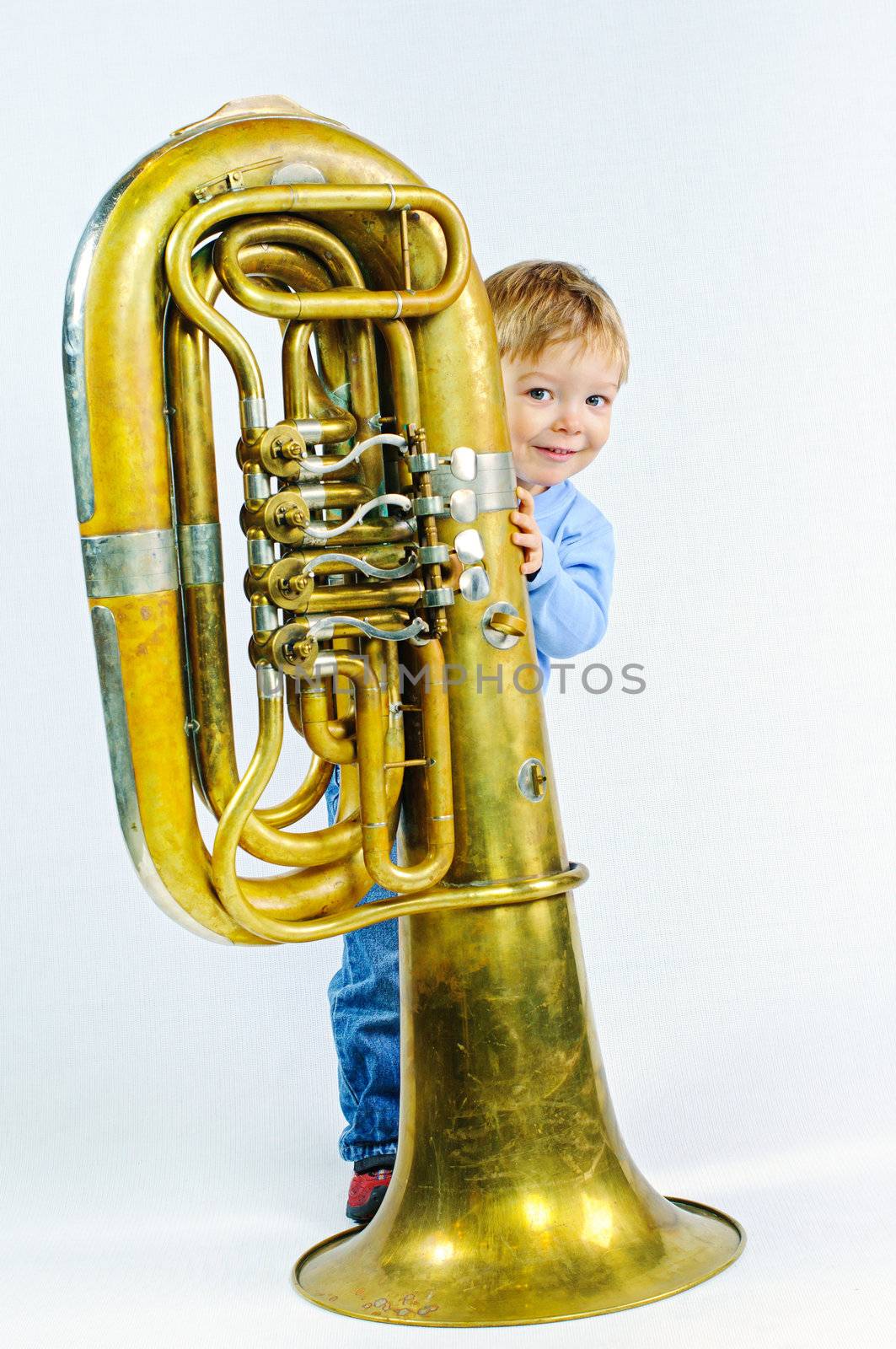 Little musician. Little cute boy and tuba