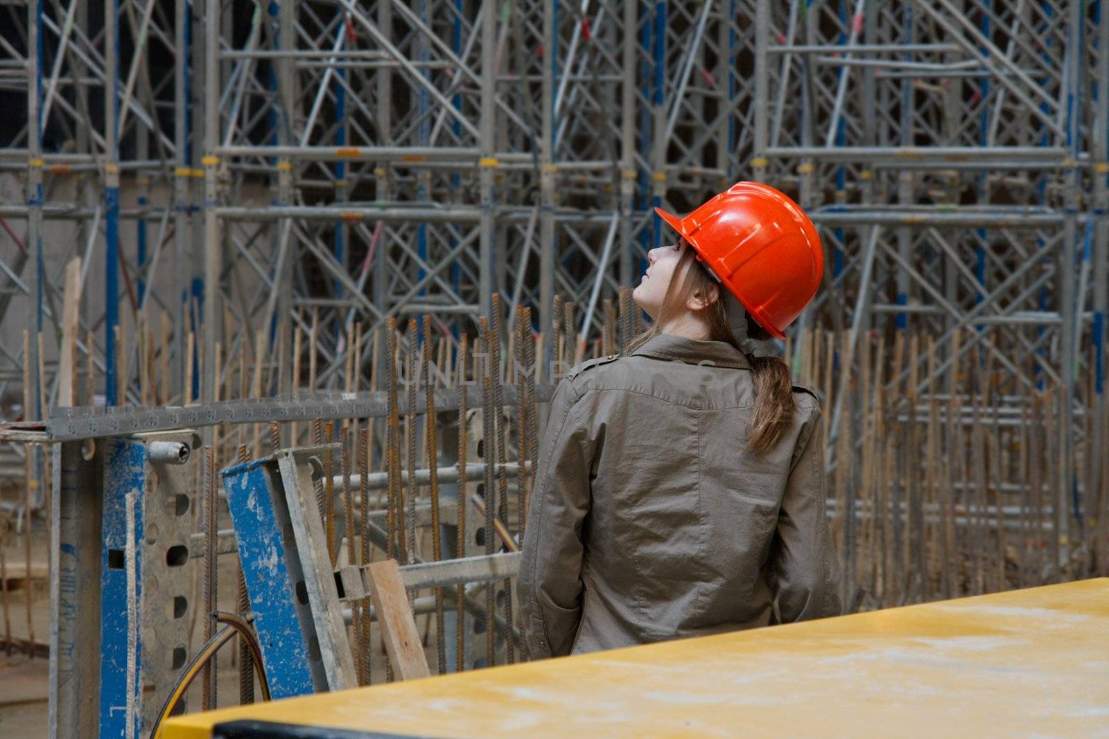 Construction site with female engineer checking things