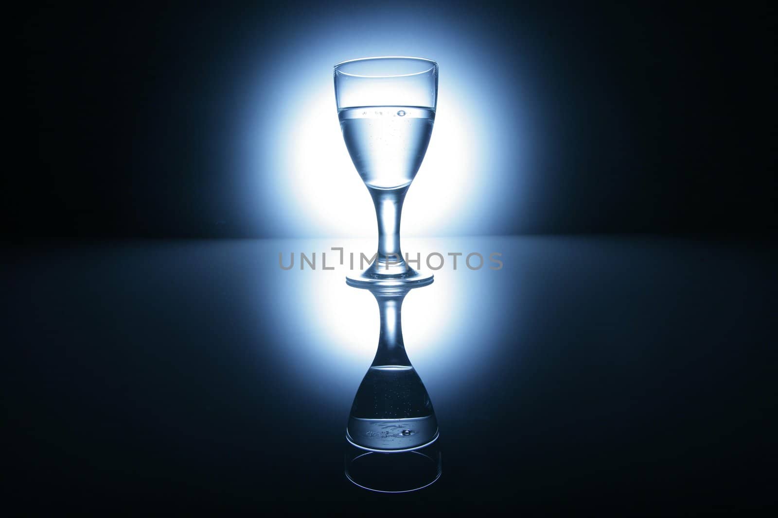 water glass on reflecting ground shimmering blue