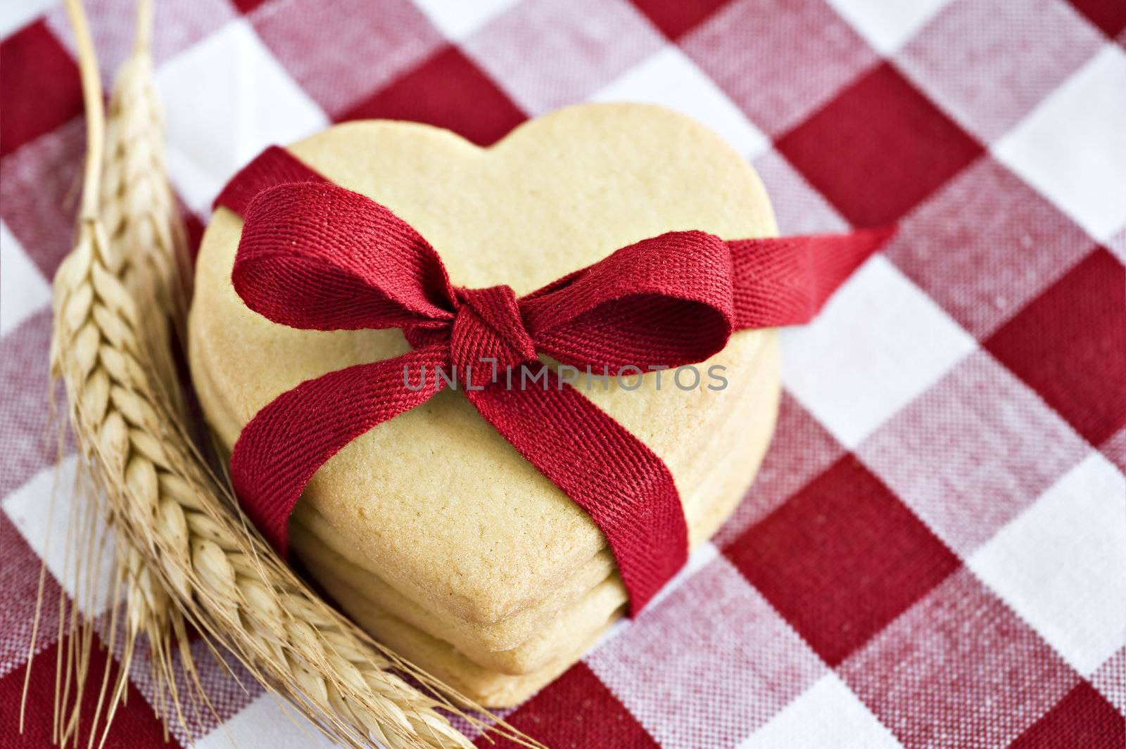 Heart shaped cookies with a red ribbon on cloth