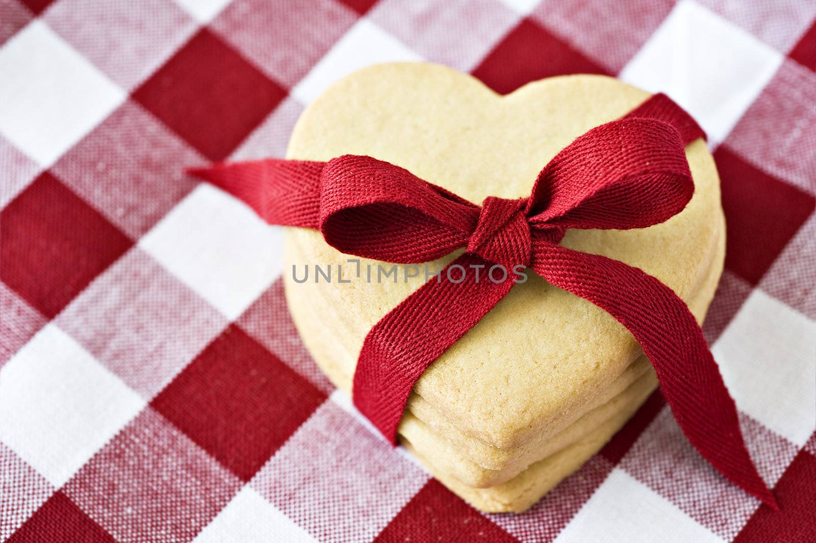 Heart shaped cookies with a red ribbon on cloth