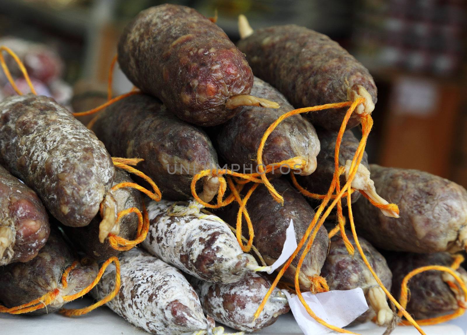 Image of french sausages on a shelf in a butcher's shop.