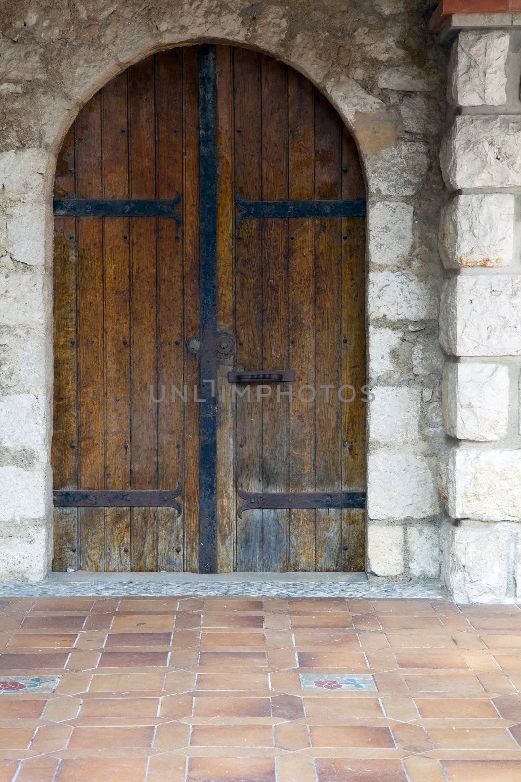 Old wooden door in stone building
