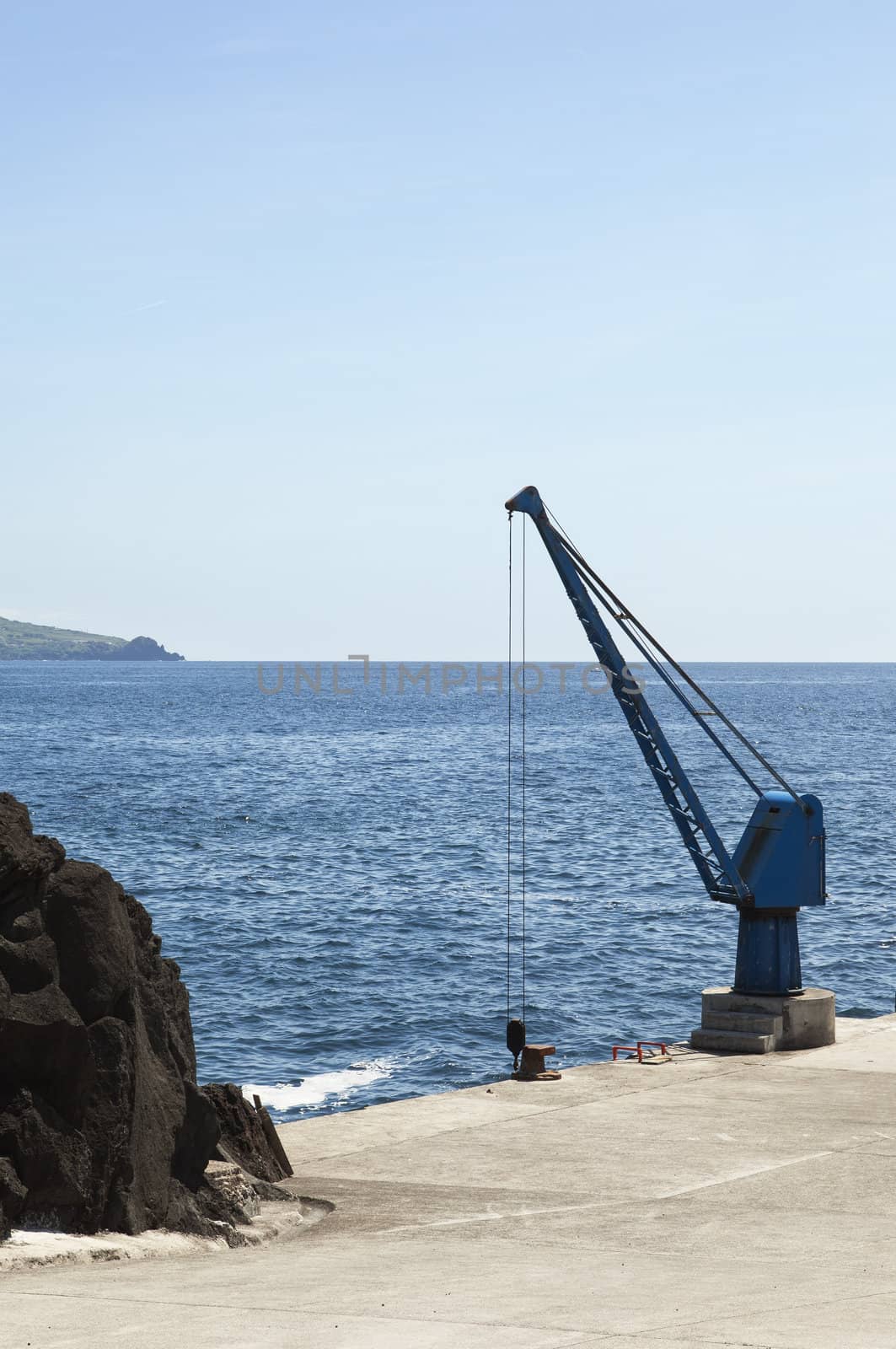 Port crane in a small harbor, Pico, Azores