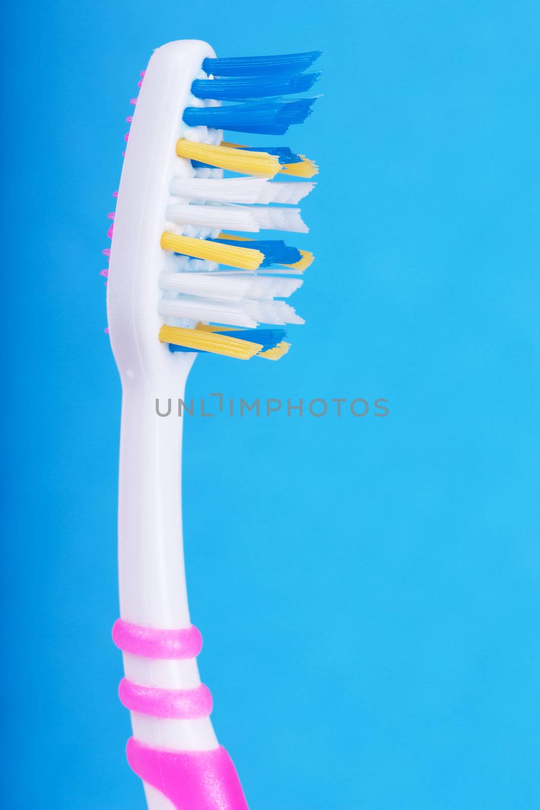 Closeup view of toothbrush over blue background