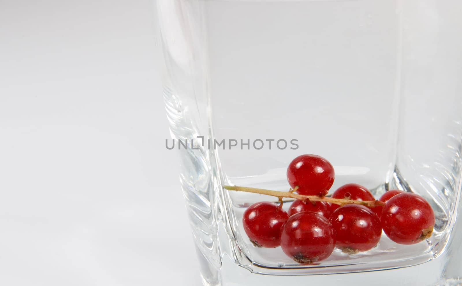 Red currant in a transparent glass