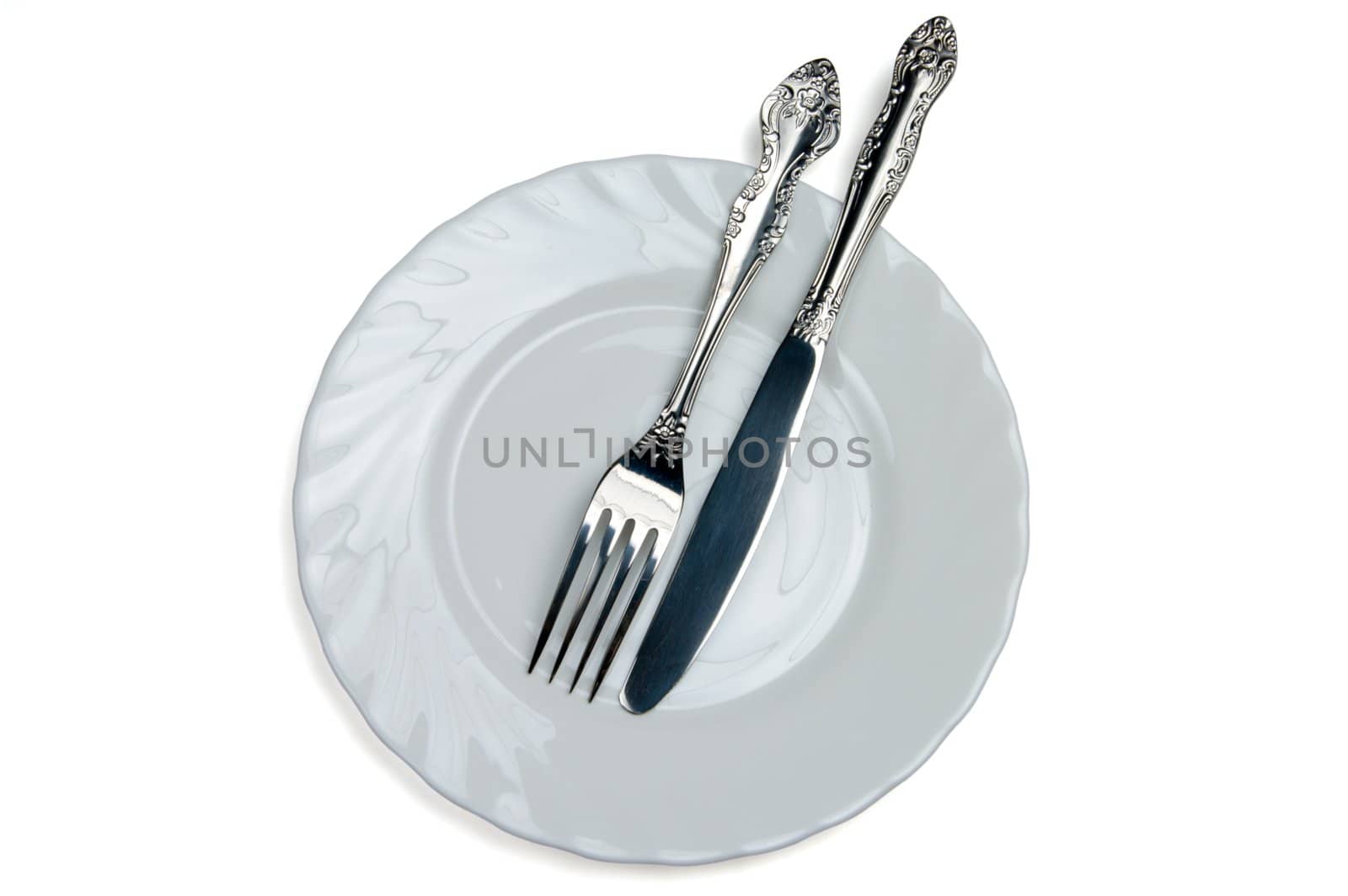 Knife and fork on a white plate