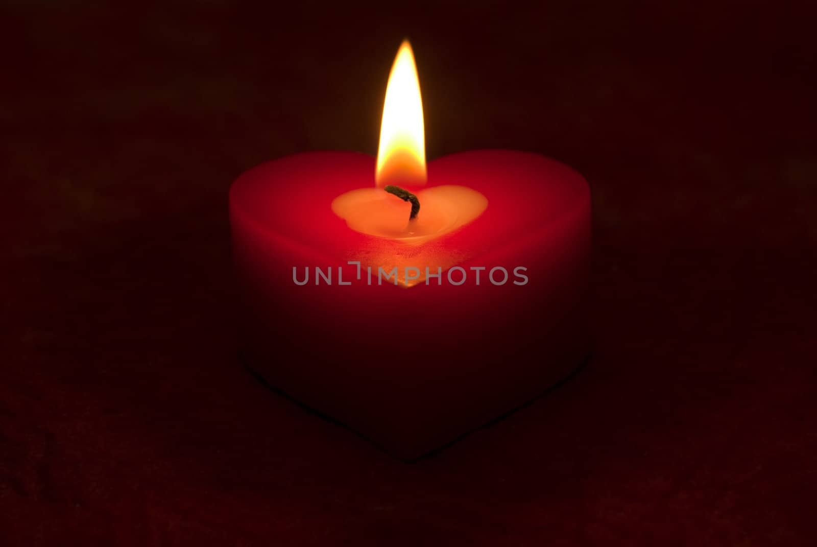 Romantic heart shaped candle and candlelight