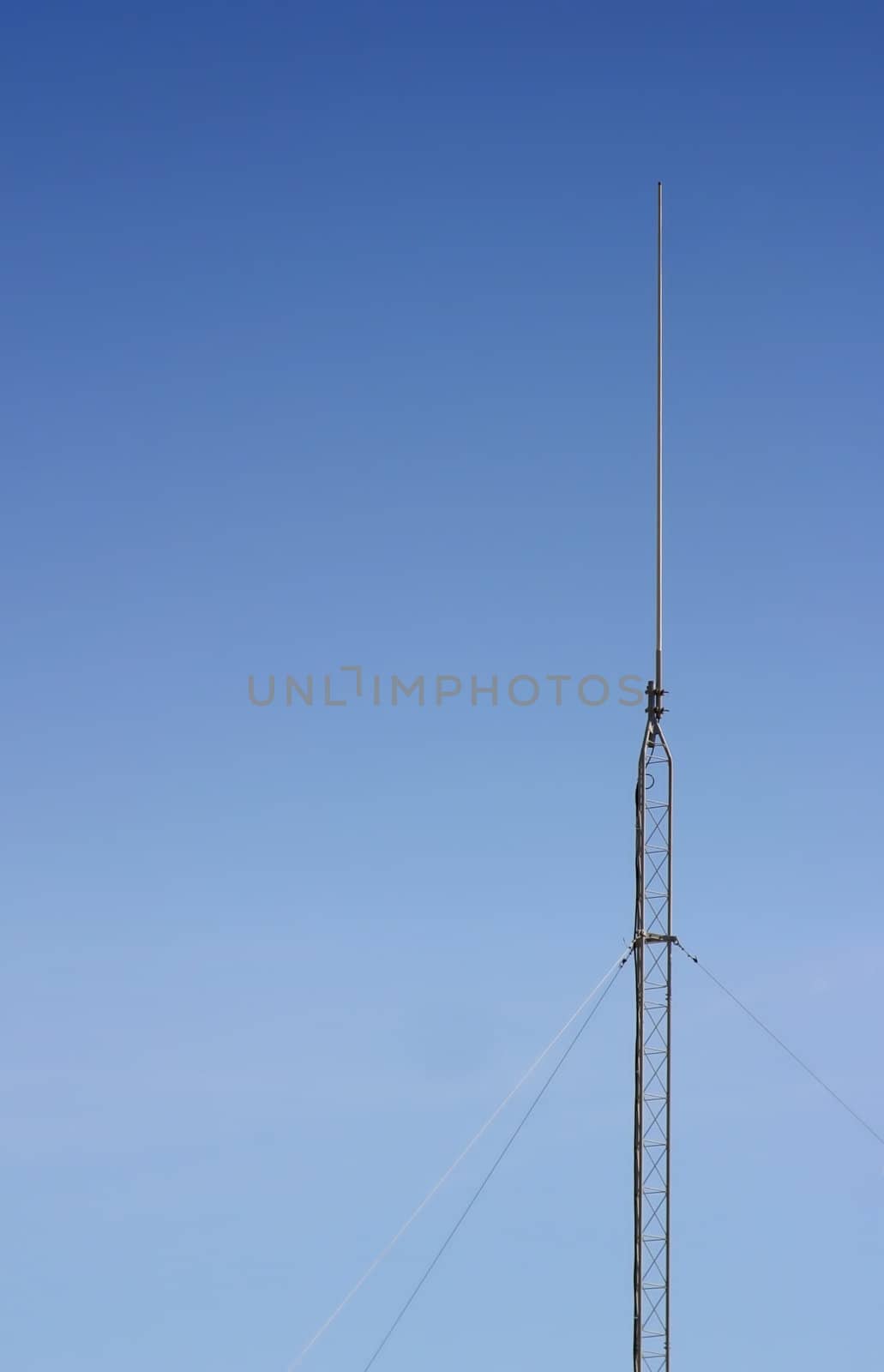 Radio antenna with the blue sky as a background