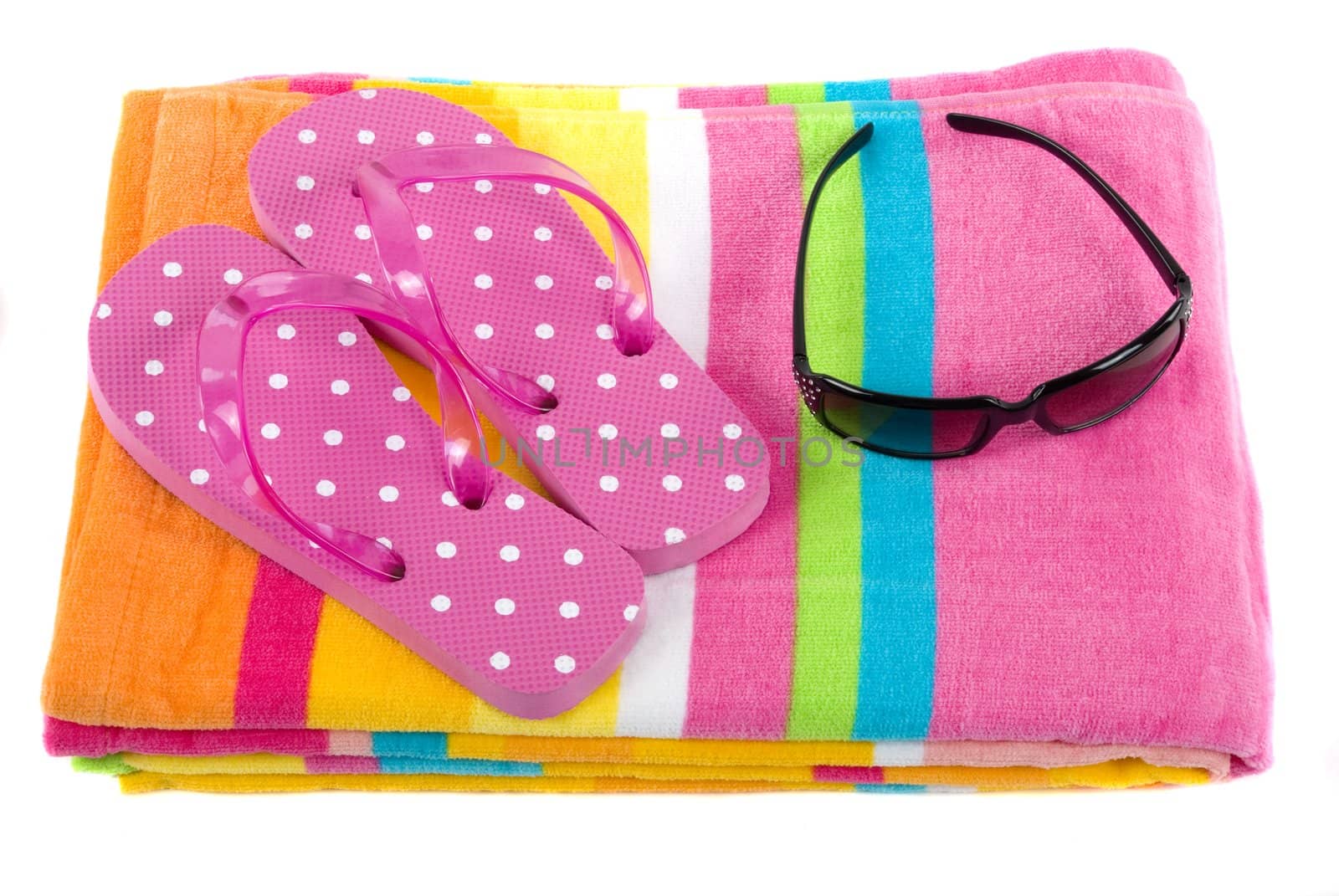 Colorful summer beachwear (flip flops), towel, and sunglasses
