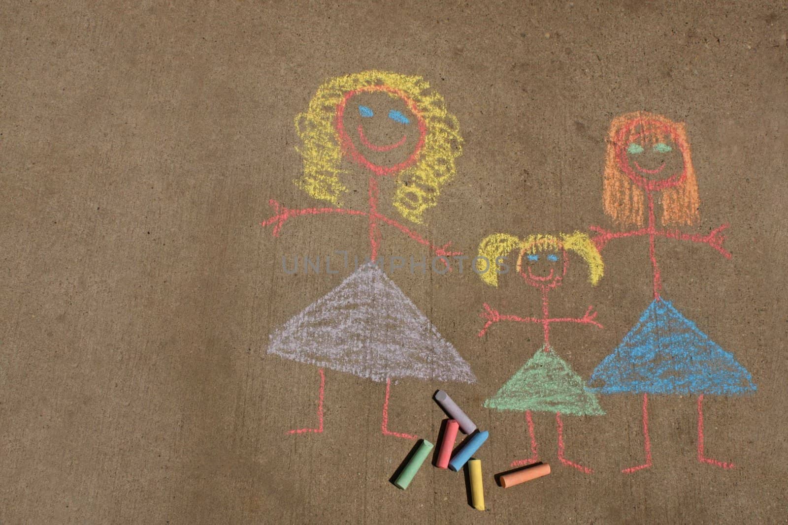 Concept image for gay parenting or gay marriage; a chalk child's drawing on a sidewalk or driveway, of two women and a female child.