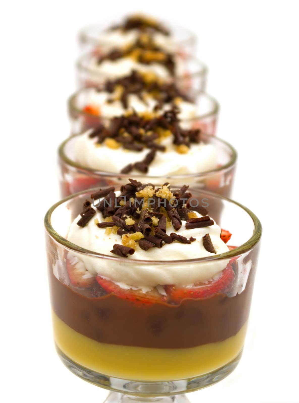 Trifle with chocolate pudding, vanilla pudding, strawberries, chocolate cake pieces, whip cream, walnuts and chocolate curls