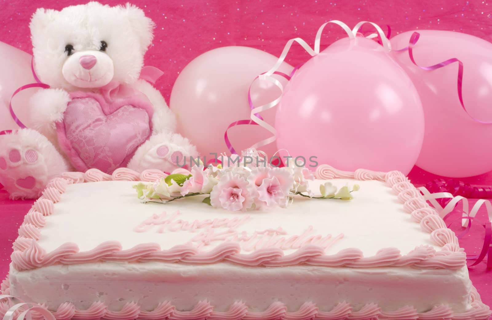 Delicious beautifully decorated bithday cake, teddy bear and balloons