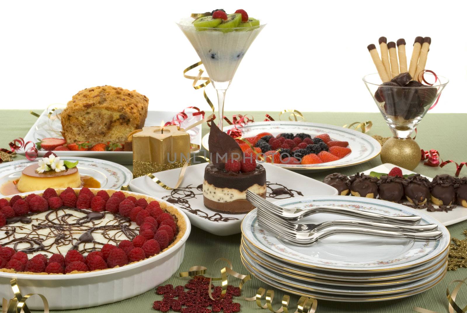 Elegant table with many desserts and fruits (eclair, pecan swirl cake, raspberry pie, rice pudding, cheese cake and more)