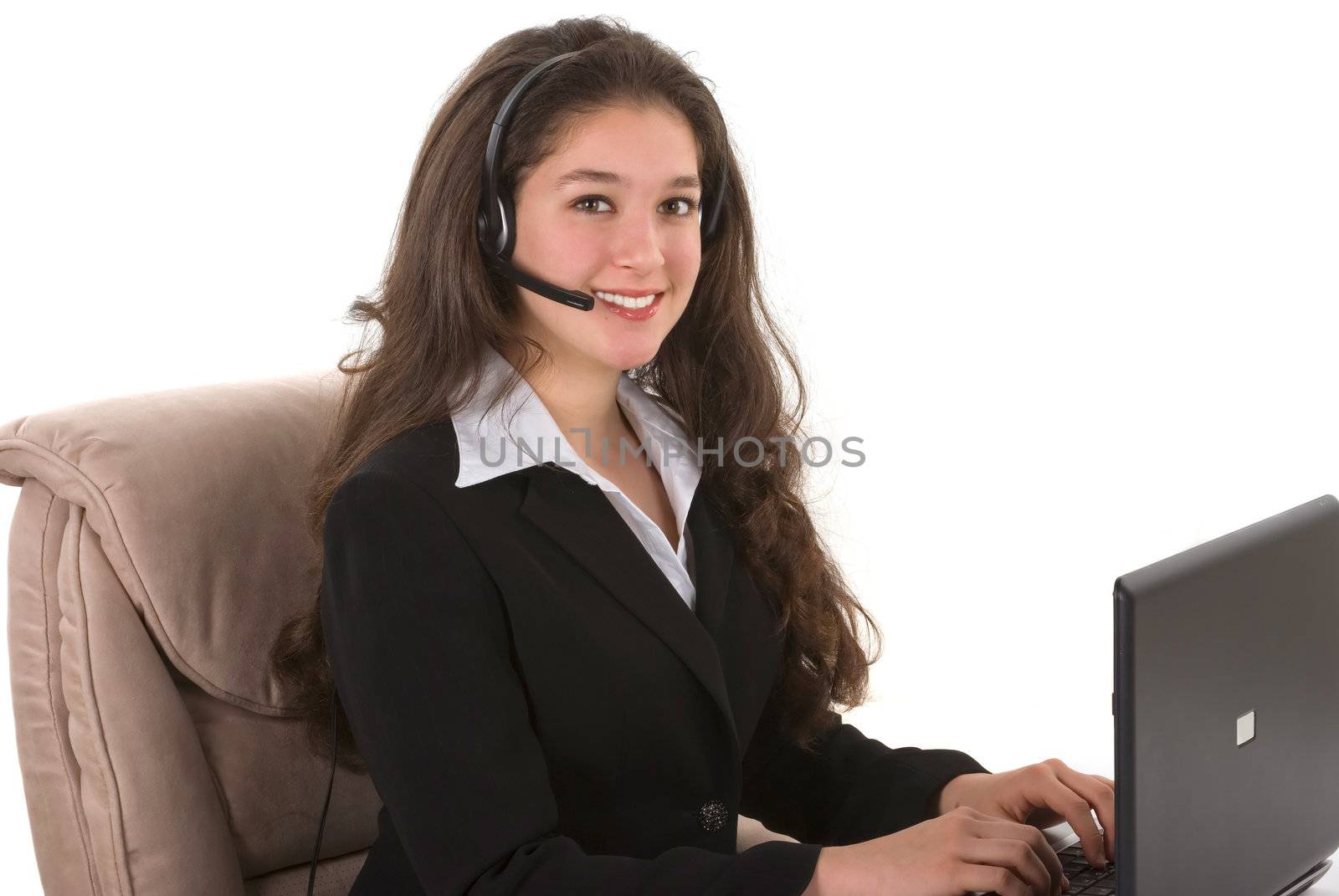 Beautiful professionally dressed customer representative with her headset and computer