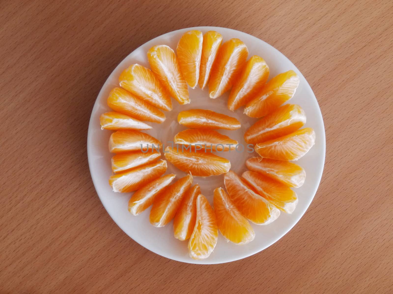 tangerine slices on a wooden table in plate