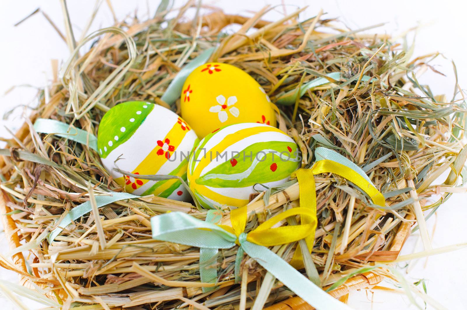 Closeup basket with colorful Easter Eggs isolated in studio