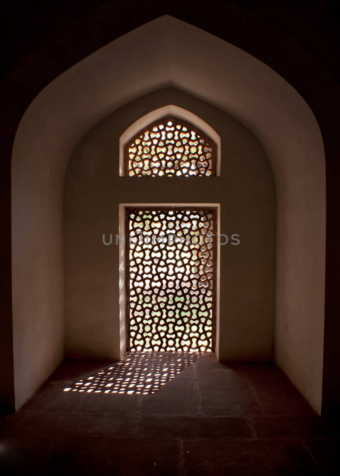 Alcove with stone screen in window at the Humayun tomb in New Delhi. by Claudine