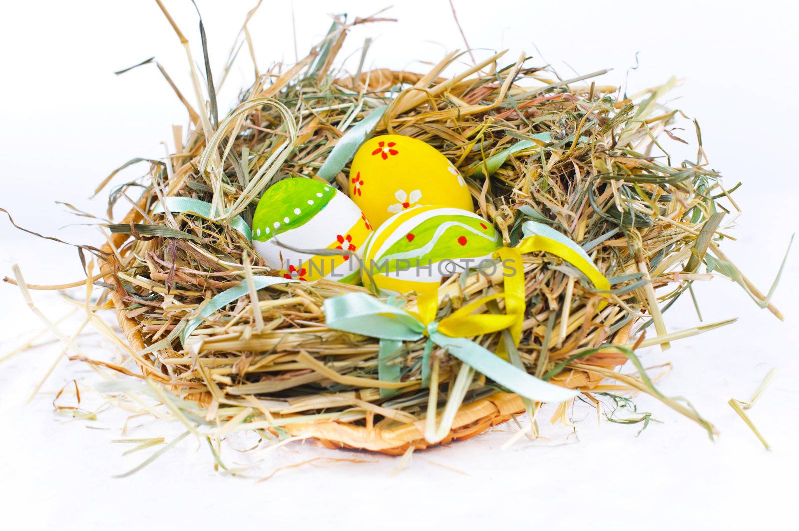 Closeup basket with colorful Easter Eggs isolated in studio