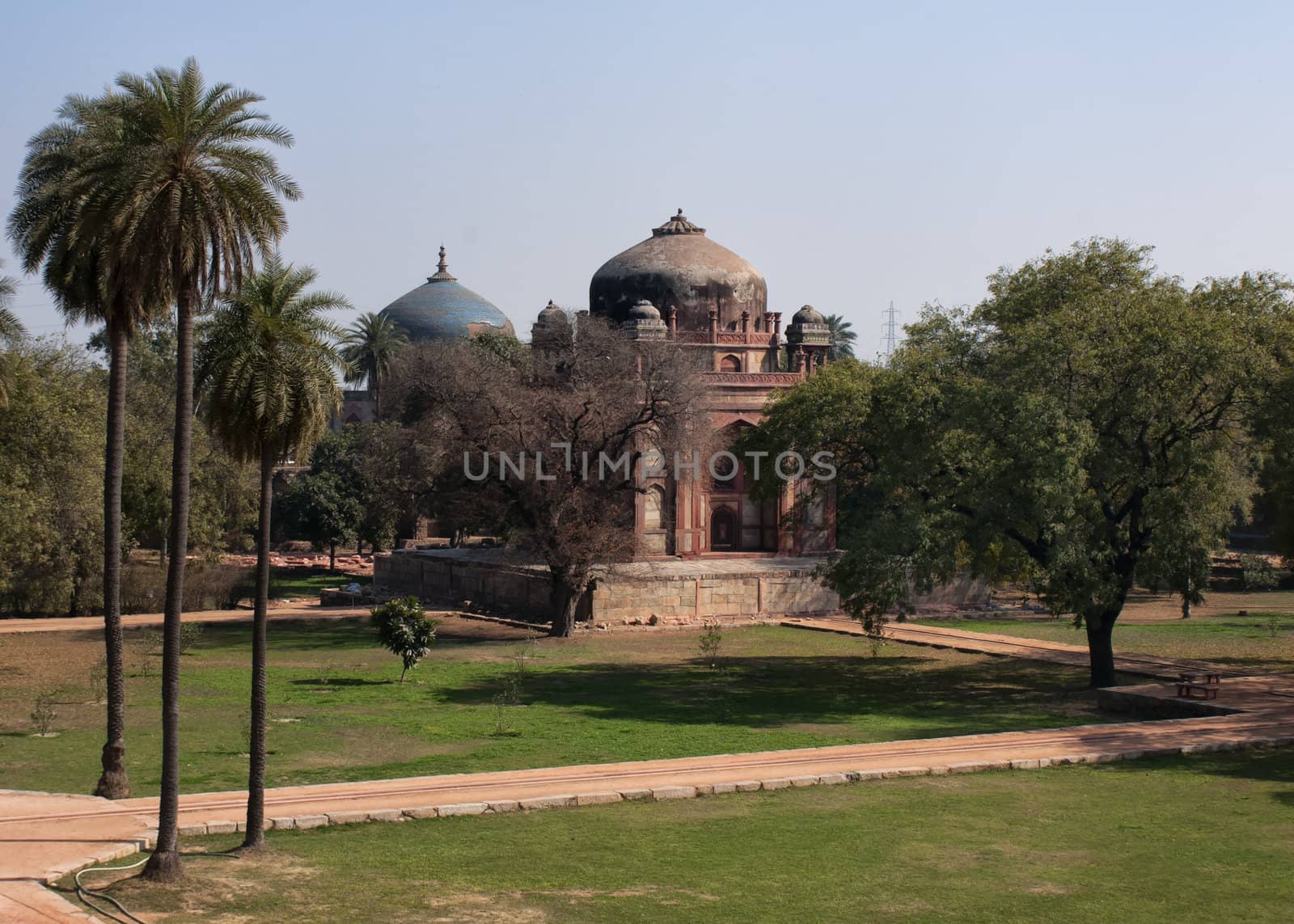 Nai-ka-gumbad or Barber's tomb, with the blue Nila Gumbad in the background at the Humayun tomb park complex. by Claudine