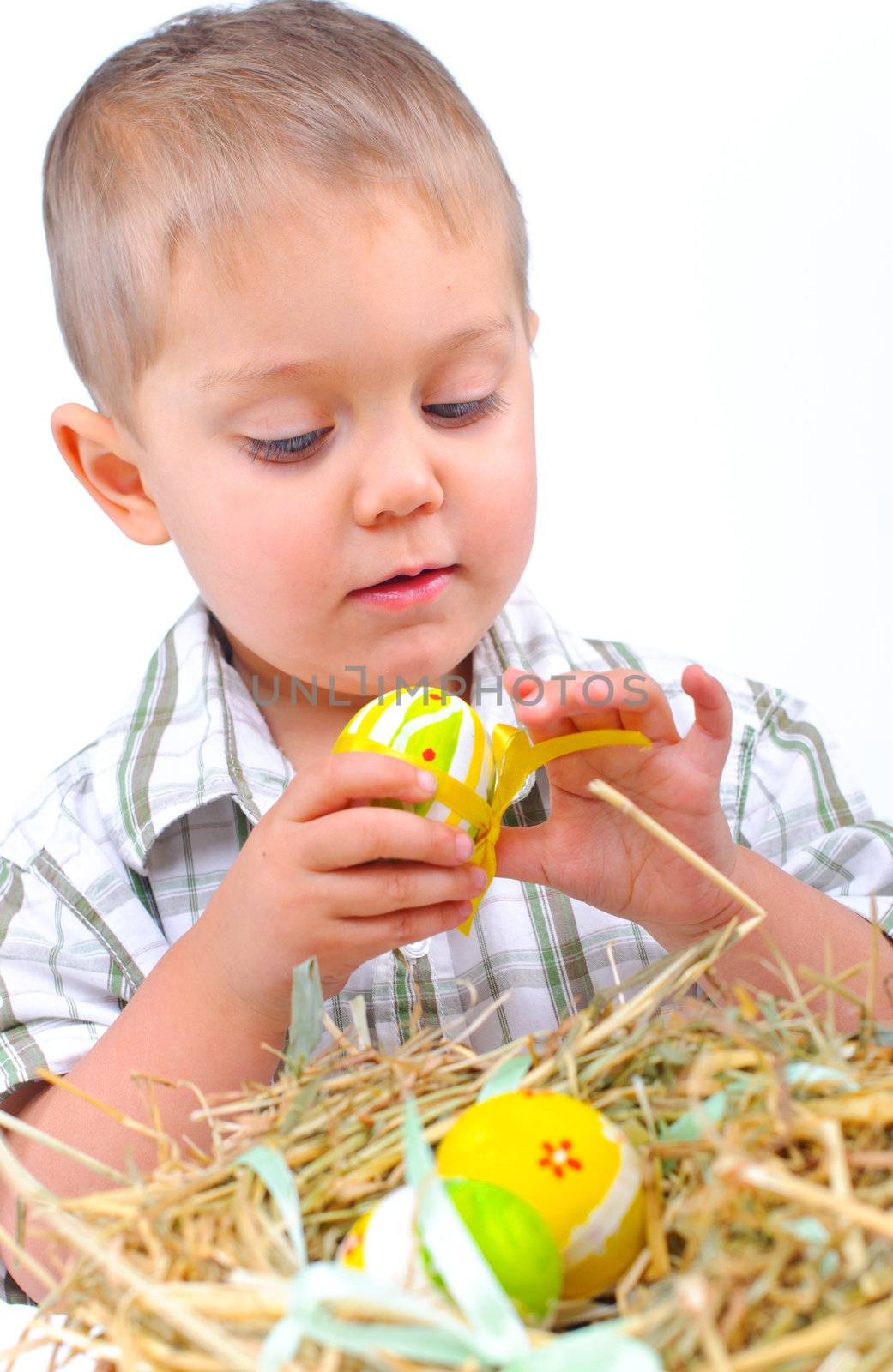 Little boy with easter eggs in basket by maxoliki